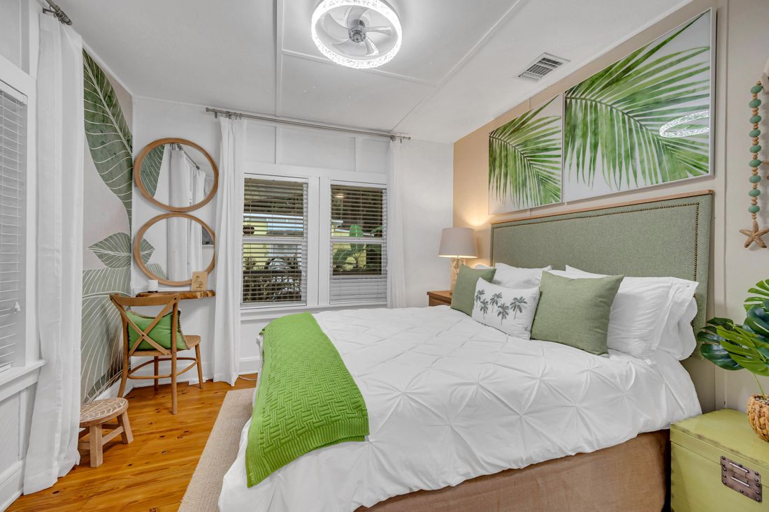 Queen bedroom with windows, closet, and connecting bathroom