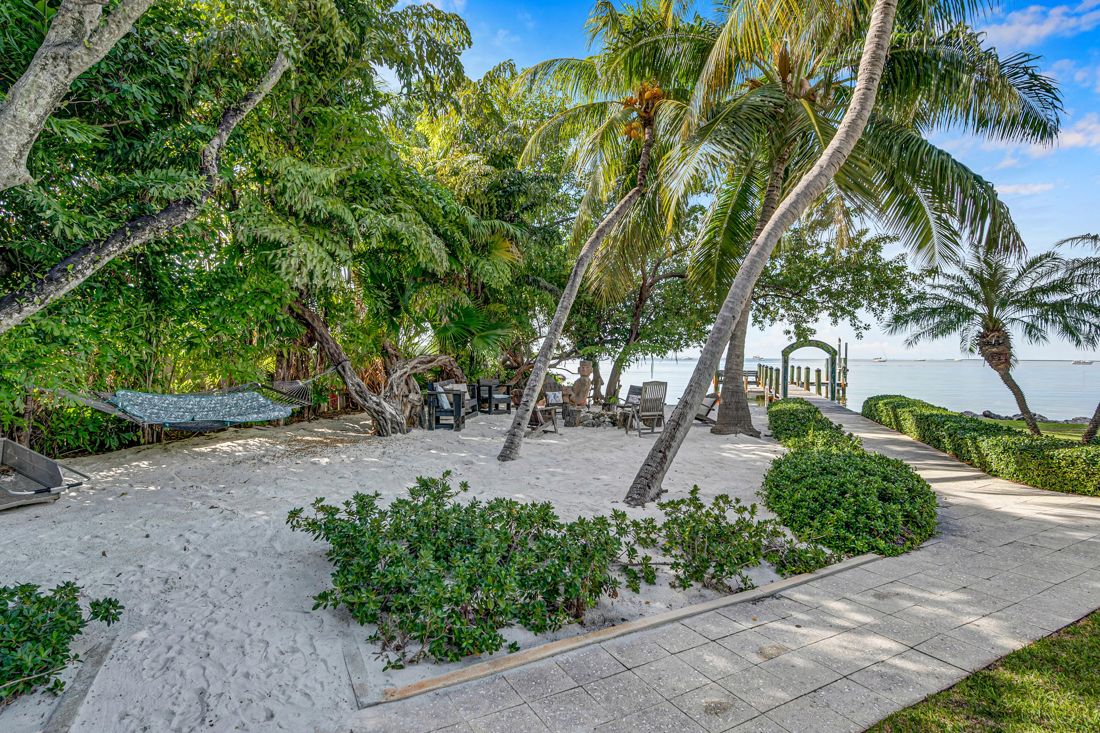 Bicycles, pool, small beach, and waterfront view at Butterfly House Islamorada